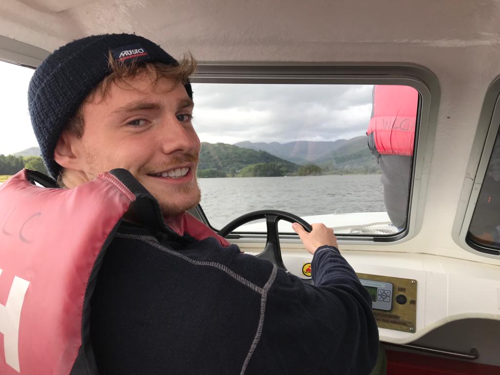 Me, driving a boat on a lake